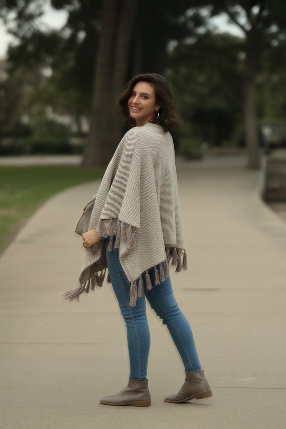 Tassel-Trimmed Knit Poncho With Skinny Denim
