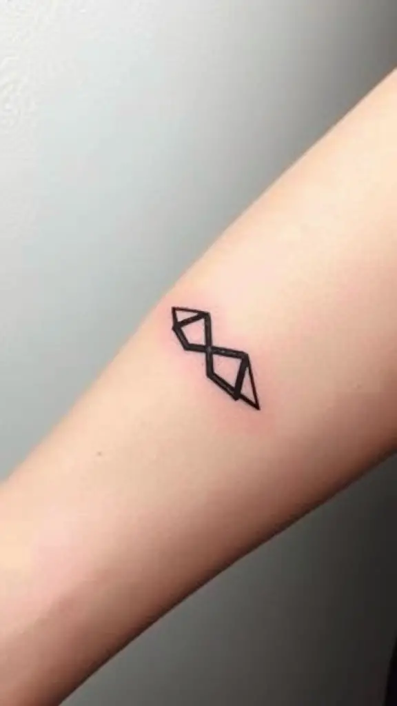 Geometric infinity symbol tattoo on forearm