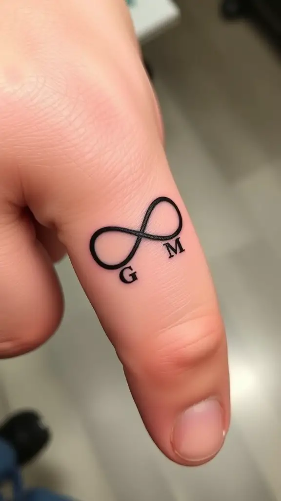 Minimalist infinity symbol tattoo with initials G and M on a finger.