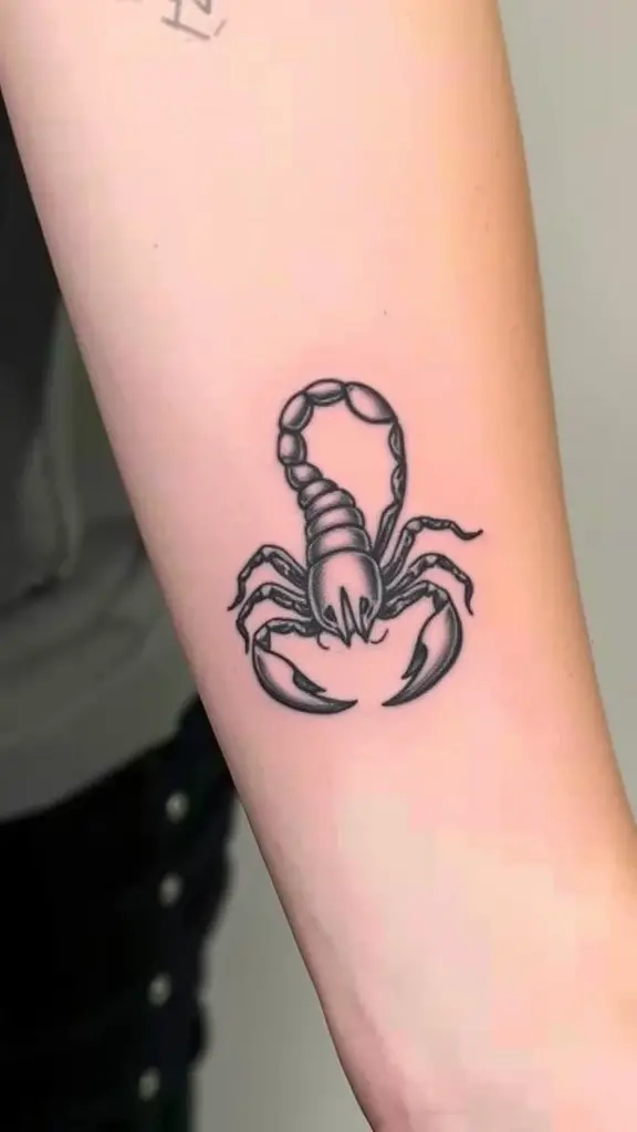 Minimalist scorpion tattoo on forearm